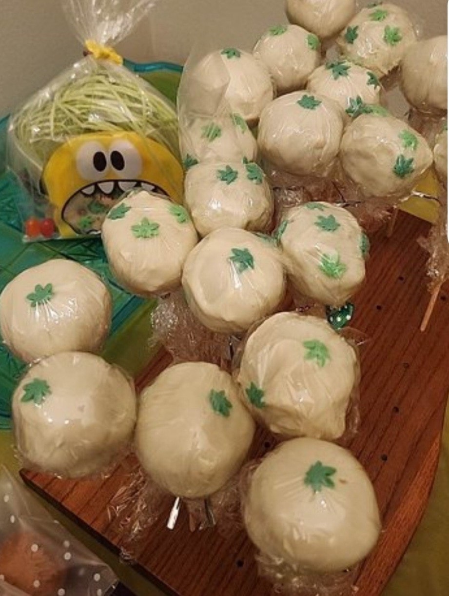 Cannabis-themed cake pops with green leaf toppers